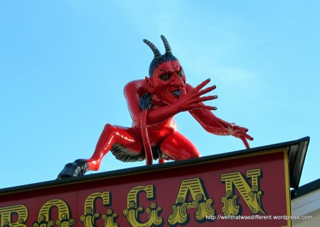A hundred-year old toboggan ride with a medieval-looking devil on it.