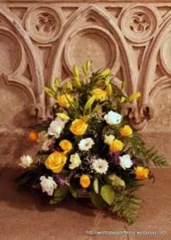 Flowers by the 16th century baptismal font